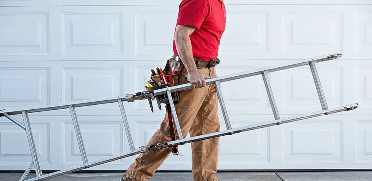 Garage door repair technician arriving with tools and ladder in Indianapolis, IN
