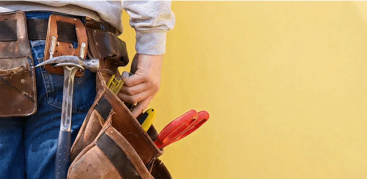 Handyman with tool belt ready for home repairs and maintenance in Indianapolis, IN