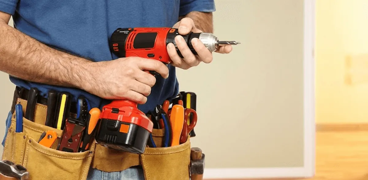 Handyman holding a power drill for home repairs and installations in Indianapolis, IN